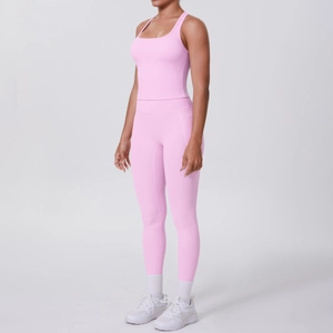 Side view of woman in pink racerback sports bra and high-waisted leggings set