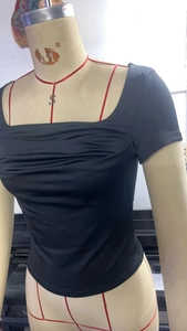 Detail view of square neck black short sleeve T-shirt with ruched chest design on a mannequin