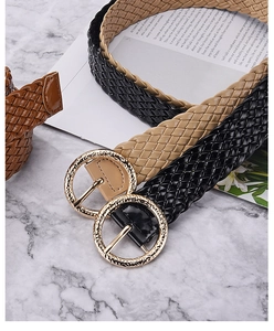 Detailed view of woven PU leather belts in black, beige, and brown with gold round buckles