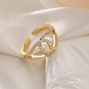 Golden open heart ring with hollow geometric design and shimmering zircon stones