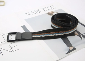Detail of striped canvas belt with double D-ring buckle on fashion magazine