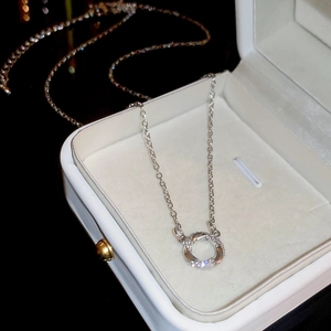 Close-up of silver zircon circle necklace displayed in a premium white jewelry gift box
