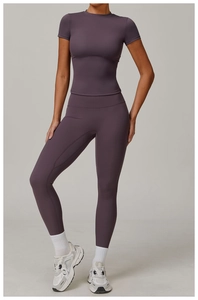 Detail view of mauve yoga set featuring slim-fit short sleeve top and high waist leggings