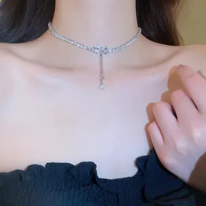 Sparkling zircon bowknot necklace with elegant pearl tassels and silver heart accents
