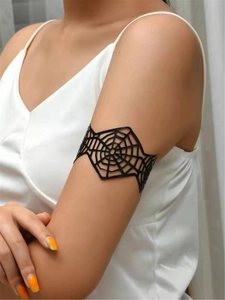 Detail of a black punk spiderweb cuff bracelet worn on wrist for Halloween style