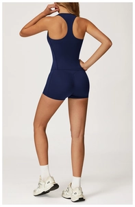 Rear view of deep blue racerback sports top and high waist compression shorts on model