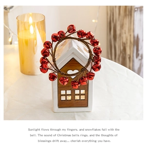 Detail of red metal bells wreath with brown woven cord for festive Christmas decoration