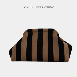 Close-up of the textured brown and black striped knit fabric on a casual cloud pouch