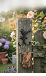 Detail of vintage cast iron bird hook with double hooks mounted on a wooden post