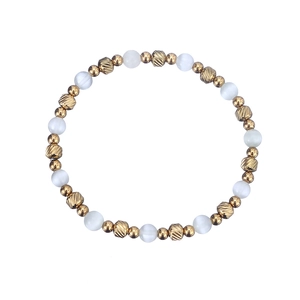 Detailed macro view of white cat eye stone beads and gold faceted metal beads on a bracelet