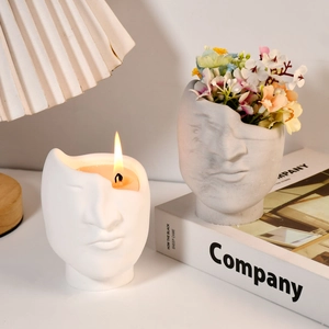 Artistic face sculpture ceramic vessels used as a candle holder and a decorative flower vase