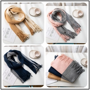 Detailed view of color-block knitted scarves with soft long tassels and textured patterns