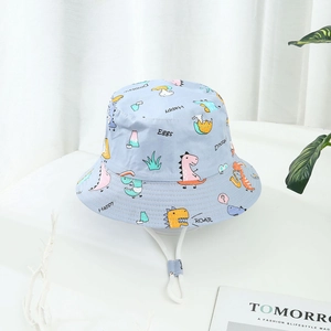 Light blue kids bucket hat with cartoon dinosaur prints and adjustable chin strap