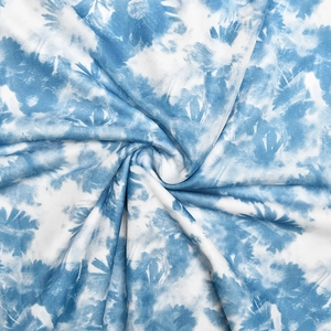 Close-up of blue and white tie-dye fabric texture with a soft breathable mesh knit