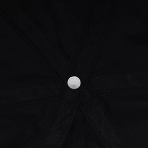 Detailed macro view of internal stitching and center rivet on black washed denim cap