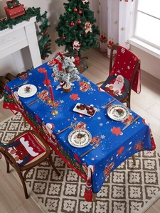 Detail of Christmas tablecloth and red chair covers with Santa Claus and reindeer patterns