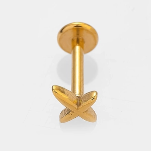 Detailed macro view of gold stainless steel cross labret stud with cubic zirconia inlay