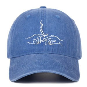 Detail of washed blue cotton baseball cap with white cigarette embroidery on the front