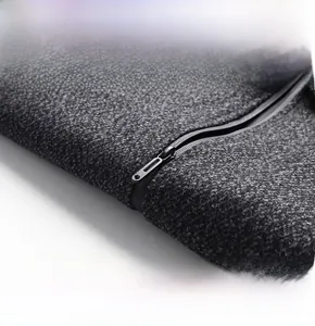 Detail of grey wool jacket featuring a high-quality black metal zipper and textured fabric
