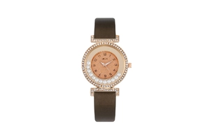 Macro shot of rose gold watch case with sparkling crystals and floating diamonds
