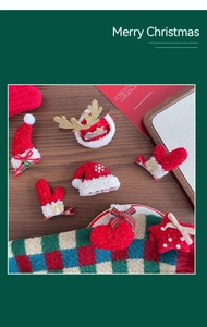 Close-up of festive plush Christmas hair clips with reindeer antlers and star designs