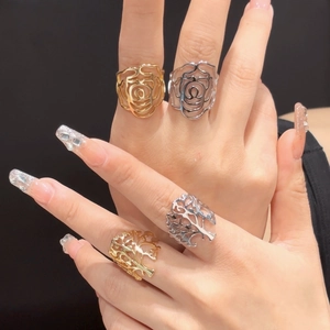 Detailed view of hollow rose and tree rings in gold and silver finish on hand