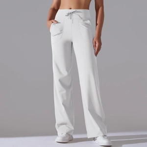 Detail of high waist white yoga wide leg pants with functional drawstring and side pockets