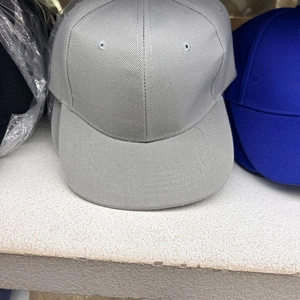 Detail shot of light grey flat brim snapback cap showing durable twill cotton fabric texture