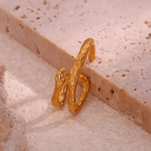 Macro view of gold-plated irregular wavy ring with unique hammered texture surface