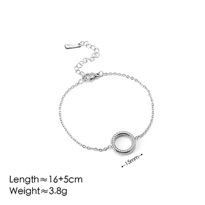 Macro shot of a silver stainless steel bracelet with a spiral textured ring charm