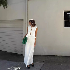 Women's white linen blend two-piece set featuring sleeveless tie-front top and maxi skirt
