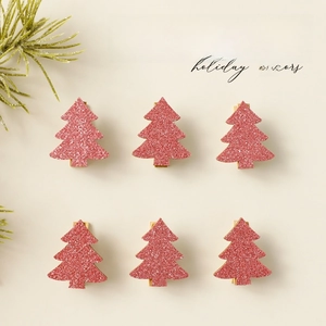 Set of 6 pink glitter Christmas tree wooden clips on minimalist white background