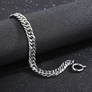 Detailed view of silver stainless steel curb chain bracelet with polished link texture