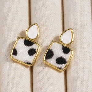 Golden earrings with pear-shaped studs and square black and white animal print drops