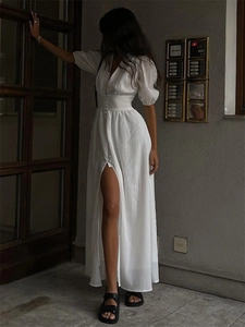 Elegant white V-neck puff sleeve maxi dress with button details and high slit