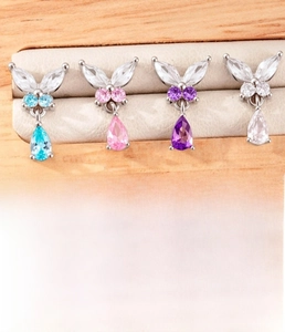Detailed view of butterfly cartilage studs in blue, pink, purple and clear zirconia crystals