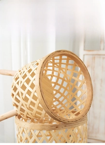 Detail of hand-woven bamboo basket showing natural wood texture and hollow grid pattern
