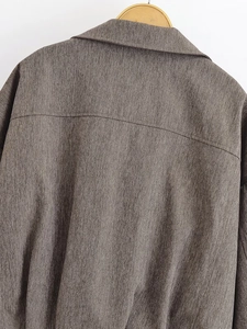 Detailed view of the herringbone texture and shoulder stitching on a casual bomber jacket