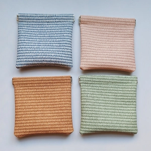 PU leather woven squeeze pouch for cosmetics and earphones in four assorted colors