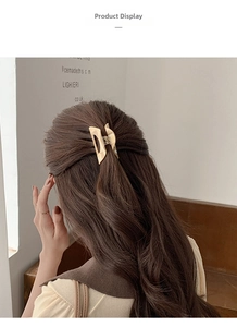 Detail of hollow rectangular acetate hair claw clip used for half-up hairstyle