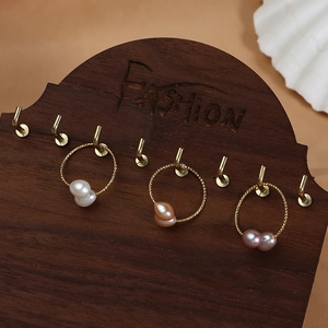 Three pairs of elegant gold plated hoops with natural freshwater pearls in three colors