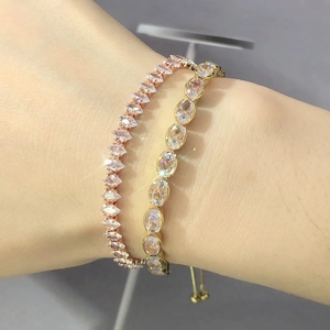 Detail showing adjustable gold and rose gold tennis bracelets with marquise zircon