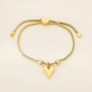 Detailed view of adjustable golden snake chain bracelet with heart charm and slider clasp