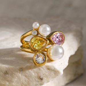 Close-up of gold ring with cluster of white pearls and colorful zircon on a stone