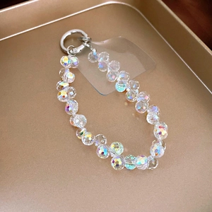 Macro shot of faceted crystal beads on a mobile strap with a silver metal spring clasp