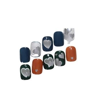 French style heart nail art stickers with navy, orange and green patterns on white base