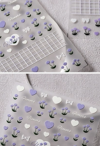 Detail of embossed purple floral nail stickers with white bows and 3D flower textures