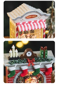 Close-up of a festive Christmas candy shop and fireplace music box with warm LED lighting
