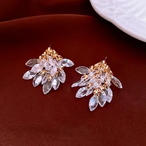 Exquisite gold rhombus tassel earrings with marquise-cut cubic zirconia on velvet background