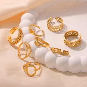 8-piece set of adjustable gold heart and geometric rings on white decorative tray